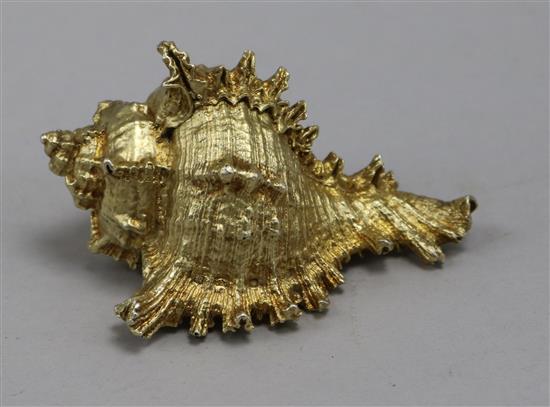 A silver gilt shell paperweight